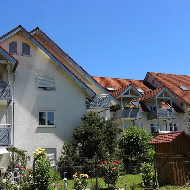 Ein modernes Gebäude mit zahlreichen Fenstern und Balkonen, das eine einladende Atmosphäre ausstrahlt.